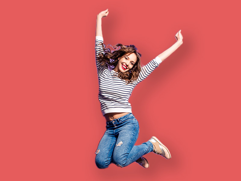 Confident Client Jumping with arms up after working with JustBU Creative